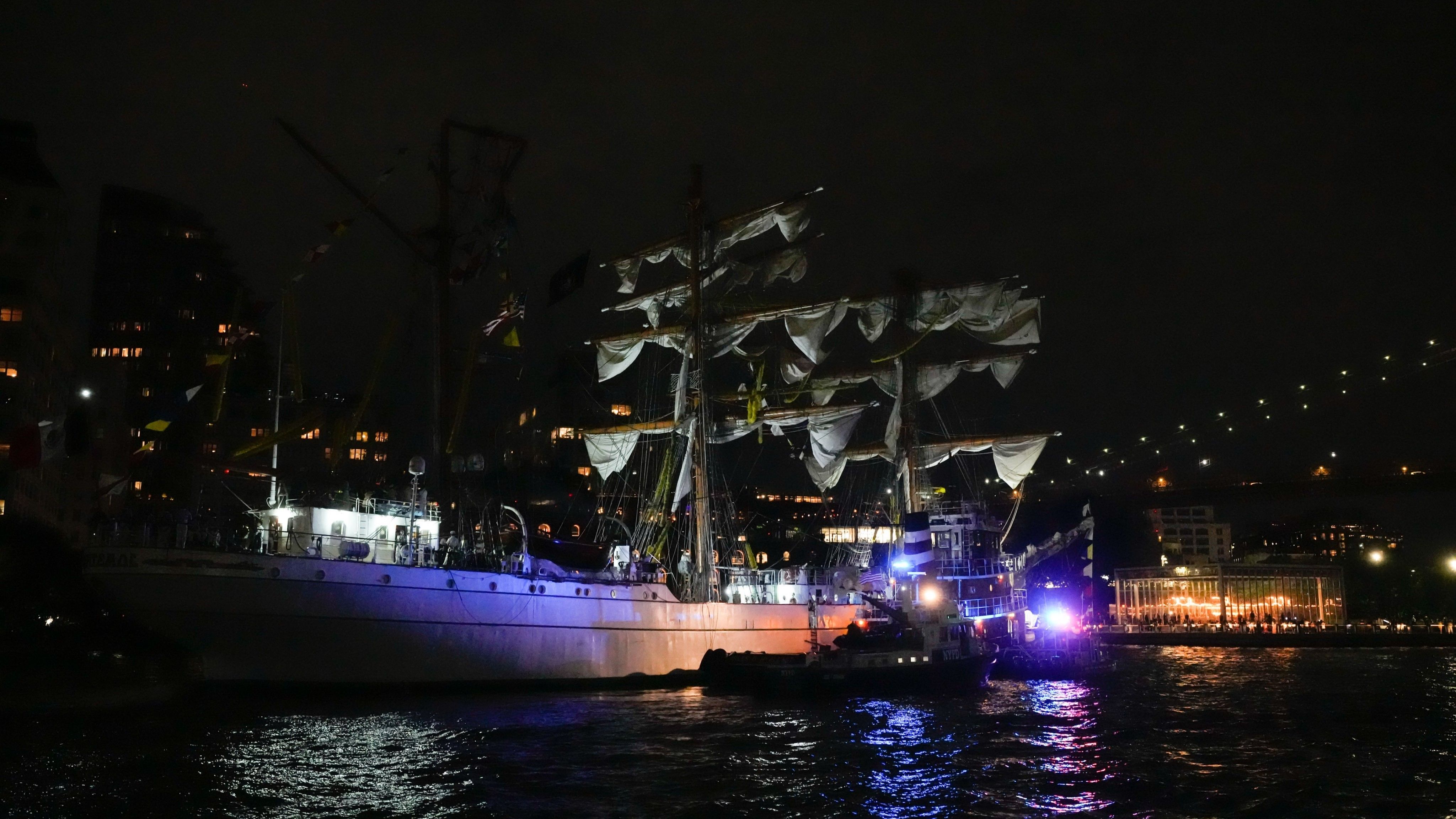 Brojni pomorski kadeti odjeveni u bijele uniforme mogli su se vidjeti kako se nalaze na palubi.